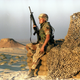 U.S. soldier rests while on guard at a relay station in the Saudi Arabian dessert (1990). AP
